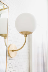 Mitzi-Carrie Sconce - Modern Matte White Glass Globe with Aged Brass Finish for Inviting Ambience